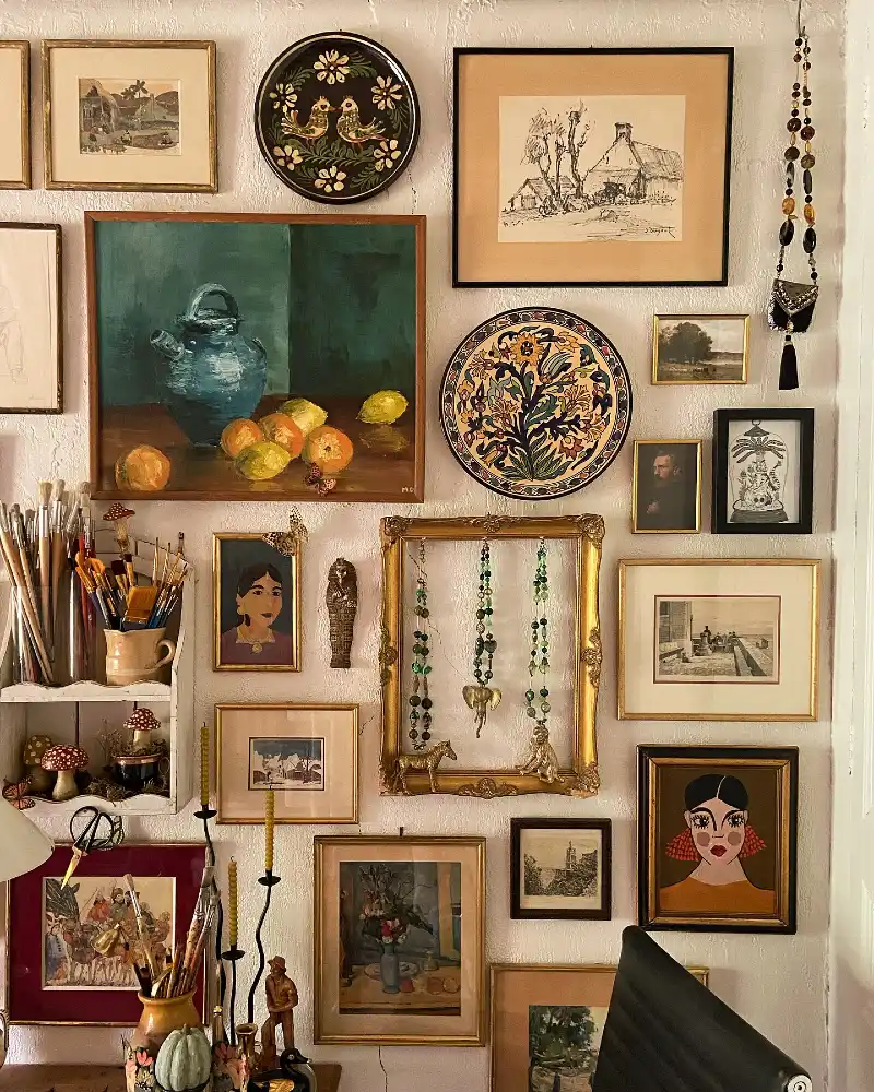 Maximalist Gallery Wall Featuring Ornate Gold Frames and Art Deco Style Portraits