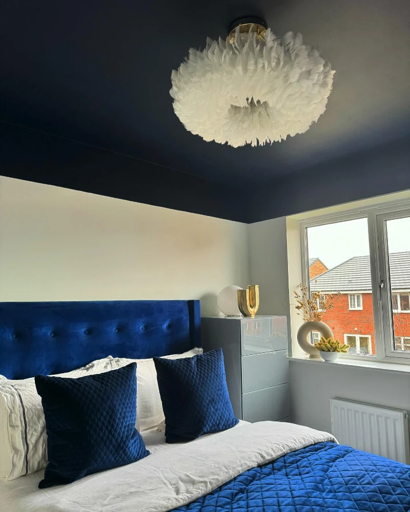 Midnight Navy Ceiling Drop with Fluffy Feather Pendant and Royal Blue Velvet Headboard