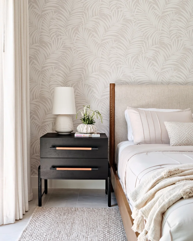 Minimalist Black Floating-Style Nightstand Against Soft Palm-Leaf Wallpaper