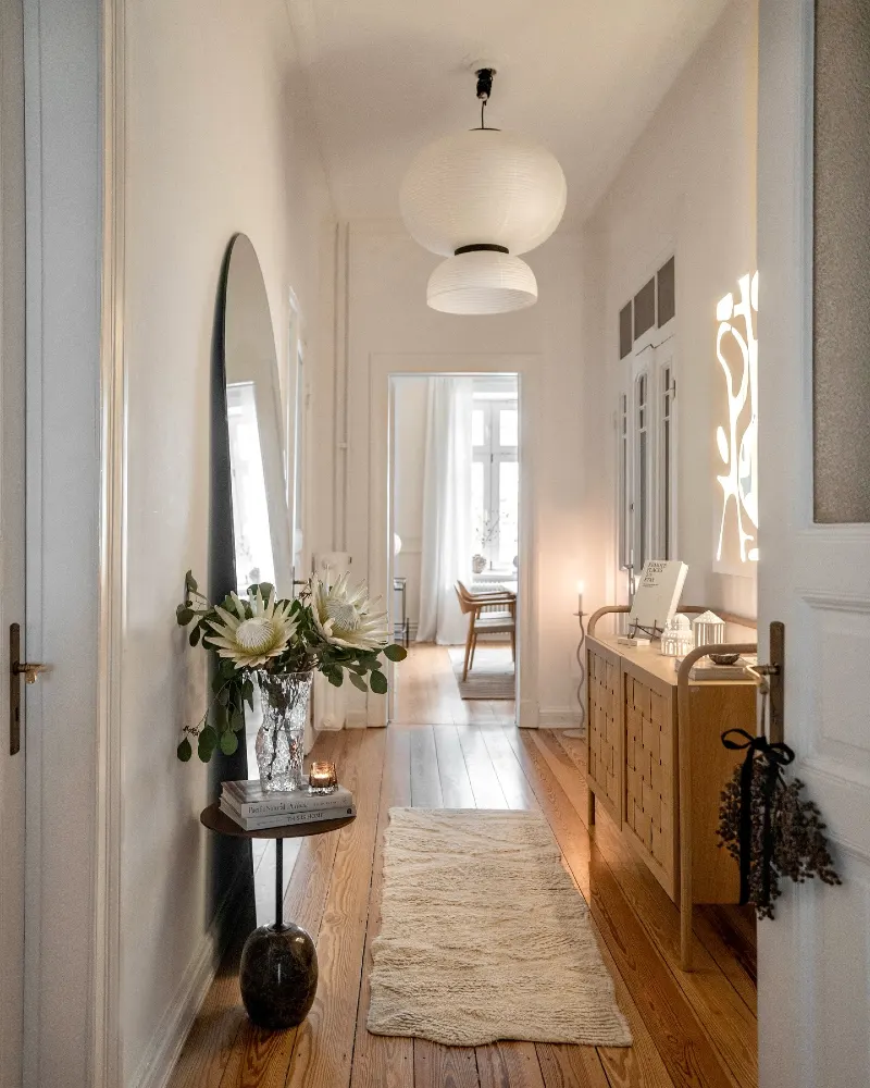 Minimalist Entryway with Sculptural Paper Pendant and Tall Arched Mirror