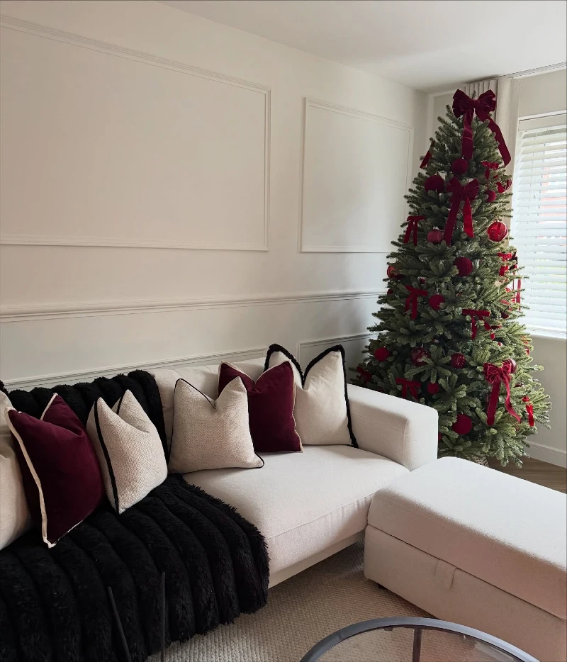 Minimalist White Sofa with Deep Burgundy Velvet Pillows and Velvet Bow Tree