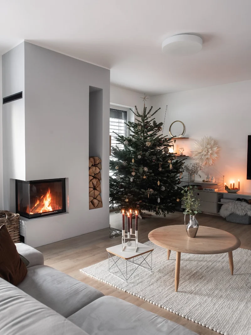 Modern Fireplace Niche with Round Oak Coffee Table and Christmas Tree