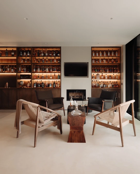 Modern Minimalist Bar Flanked by Twin Whiskey Walls