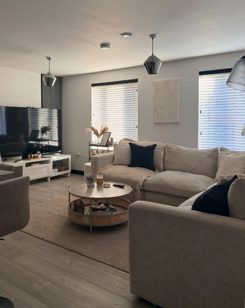 Modern Neutral Open-Plan Living Area with Slat Accent Wall and Round Coffee Table