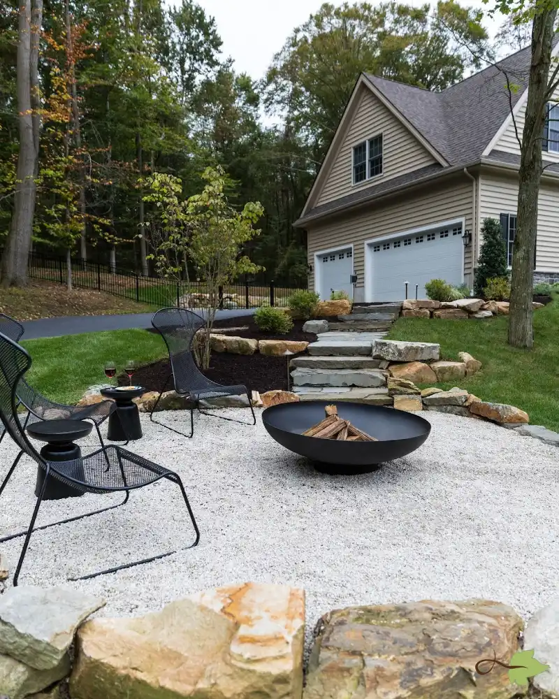 Modern Steel Fire Bowl on White Gravel with Natural Stone Terrace