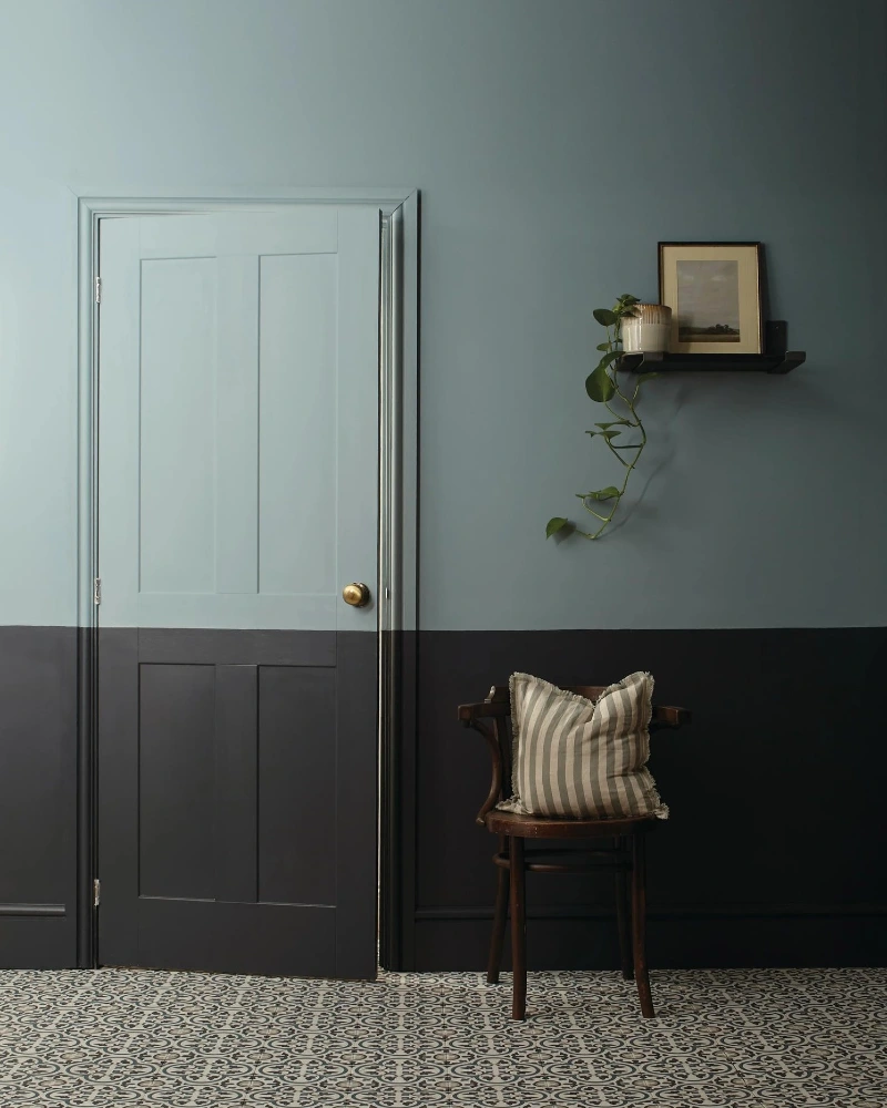 Moody Charcoal and Slate Blue Split Wall with Traditional Paneled Door and Patterned Floor Tiles