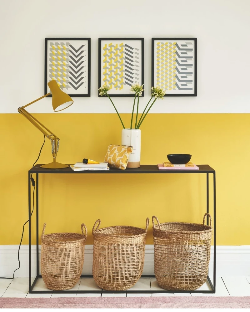 Mustard Yellow Half-Painted Wall with Slim Black Console Table and Woven Baskets