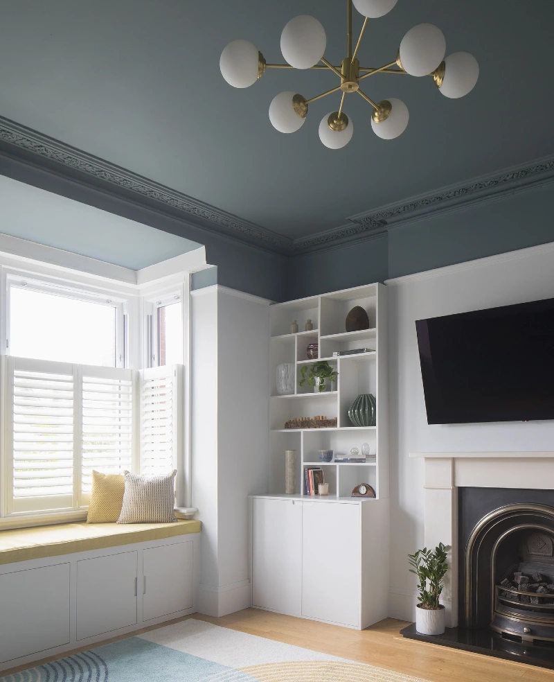 Muted Sage Frieze Wrap with Ornate Crown Molding and Brass Sputnik Chandelier