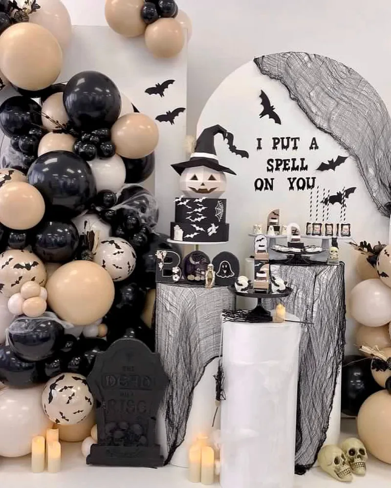 Neutral Balloon Installation with Themed Dessert Pedestals and Gothic Cheesecloth Drape
