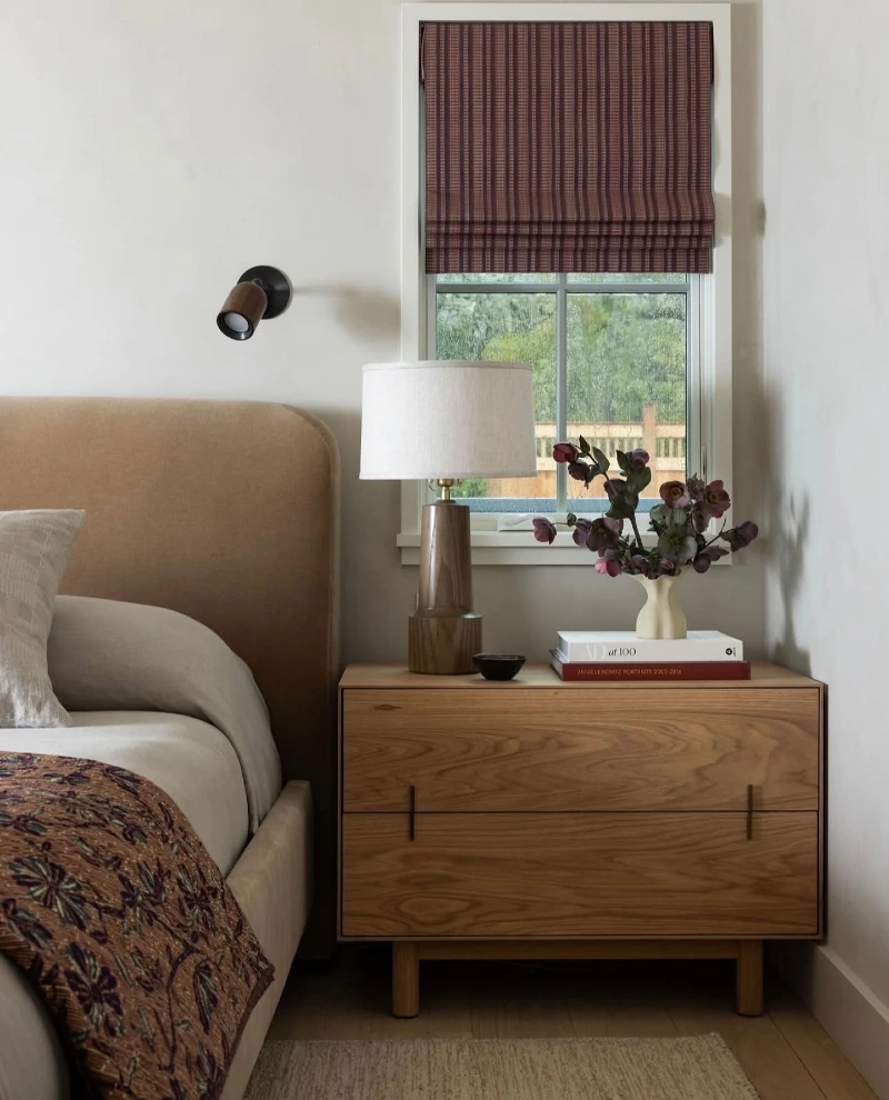 Oak Low-Profile Nightstand with Turned Wood Lamp and Plaid Roman Shade