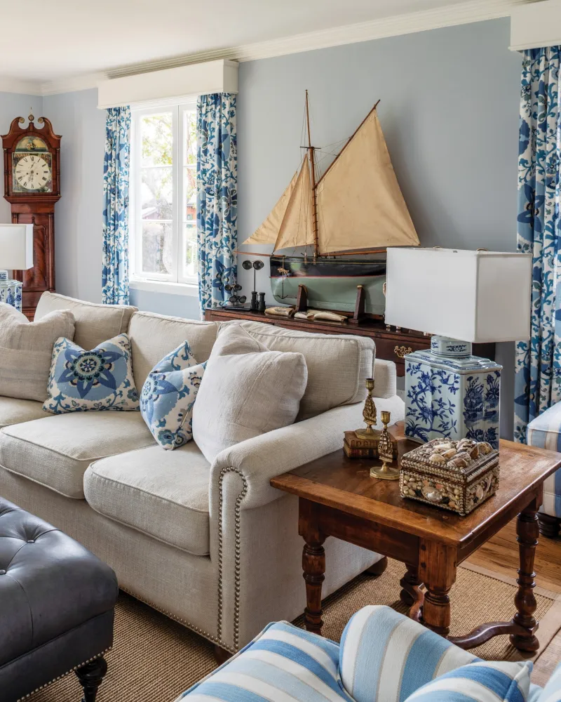 Oatmeal Roll-Arm Sofa with Model Sailboat and Blue Chintz Drapery