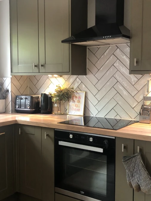 Olive Cabinets With Herringbone Tile Backsplash