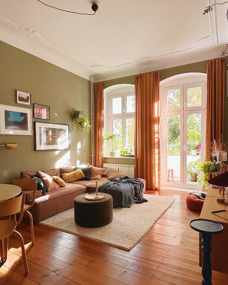 Olive Green Living Room with Rust-Colored Curtains and Sectional