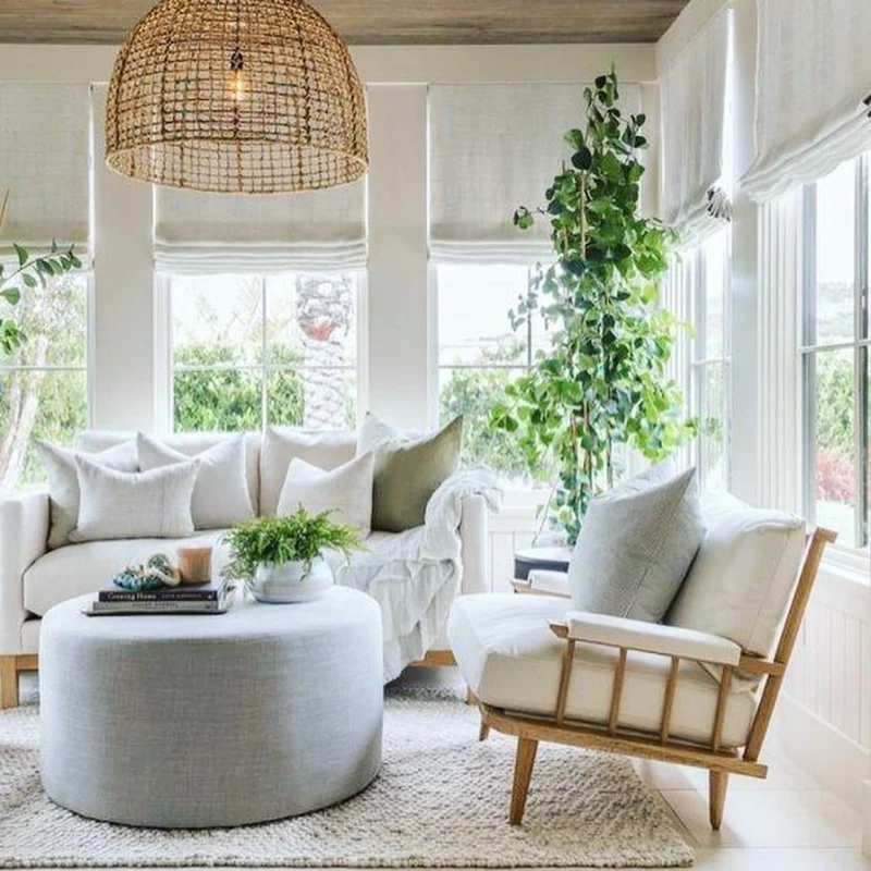 Open-Weave Rattan Dome Pendant with White Roman Shades and Wood-Framed Armchair