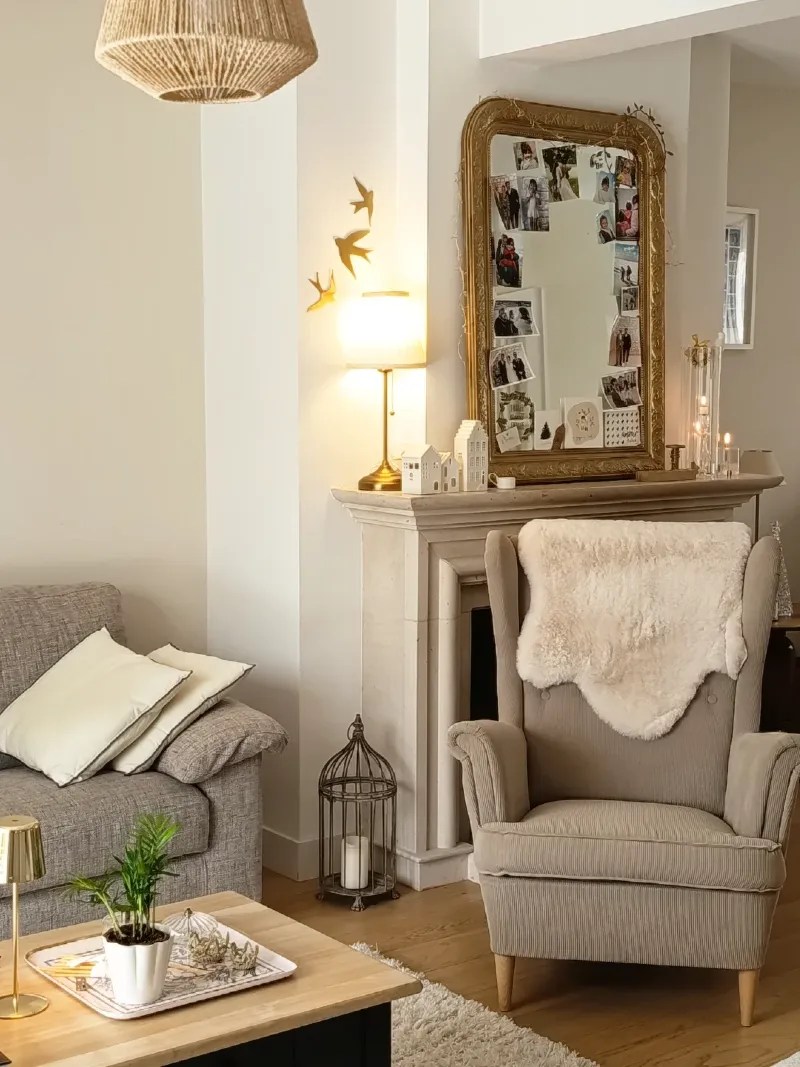 Ornate Gold Mirror with Beige Wingback Chair and Ceramic Houses