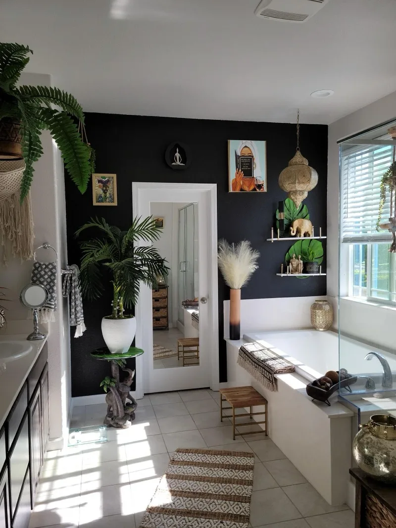 Pitch Black Bathroom Accent Wall with Mirrored Door and White Soaking Tub