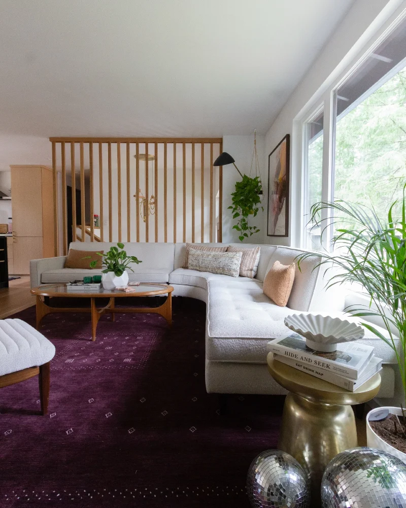 Plum Wool Rug with an Ivory Sectional and Warm Brass Accents