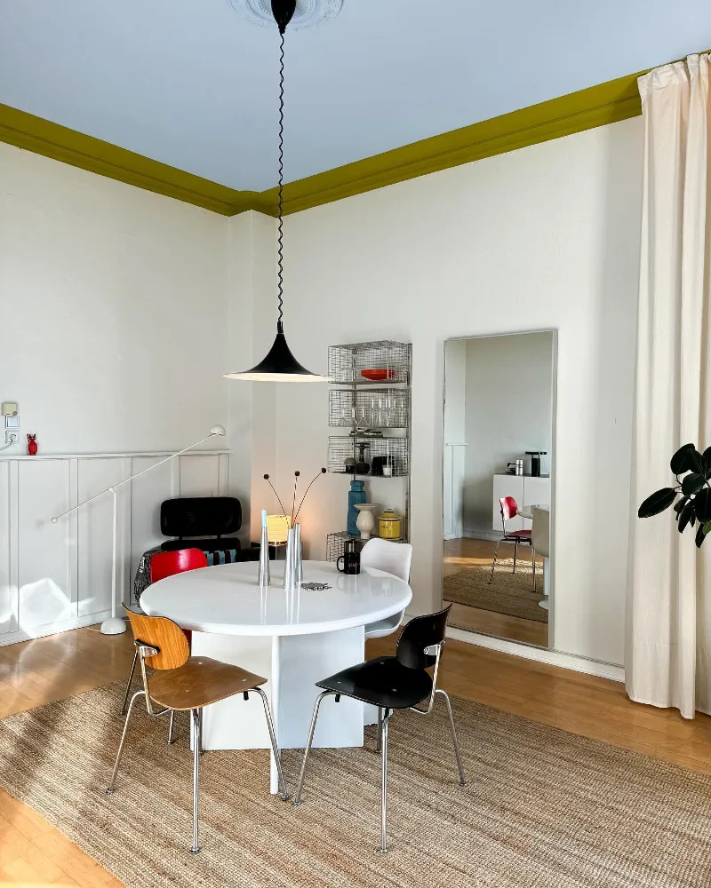 Powder Blue Ceiling with Chartreuse Crown Molding and White Round Dining Setup