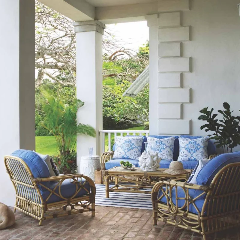 Rattan Lounge Set with Royal Blue Cushions and Striped Area Rug