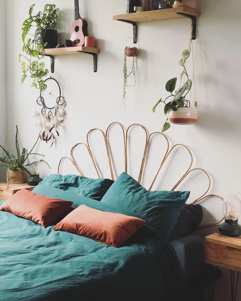 Rattan Petal Sunburst Headboard with Teal Linen Bedding and Hanging Plants