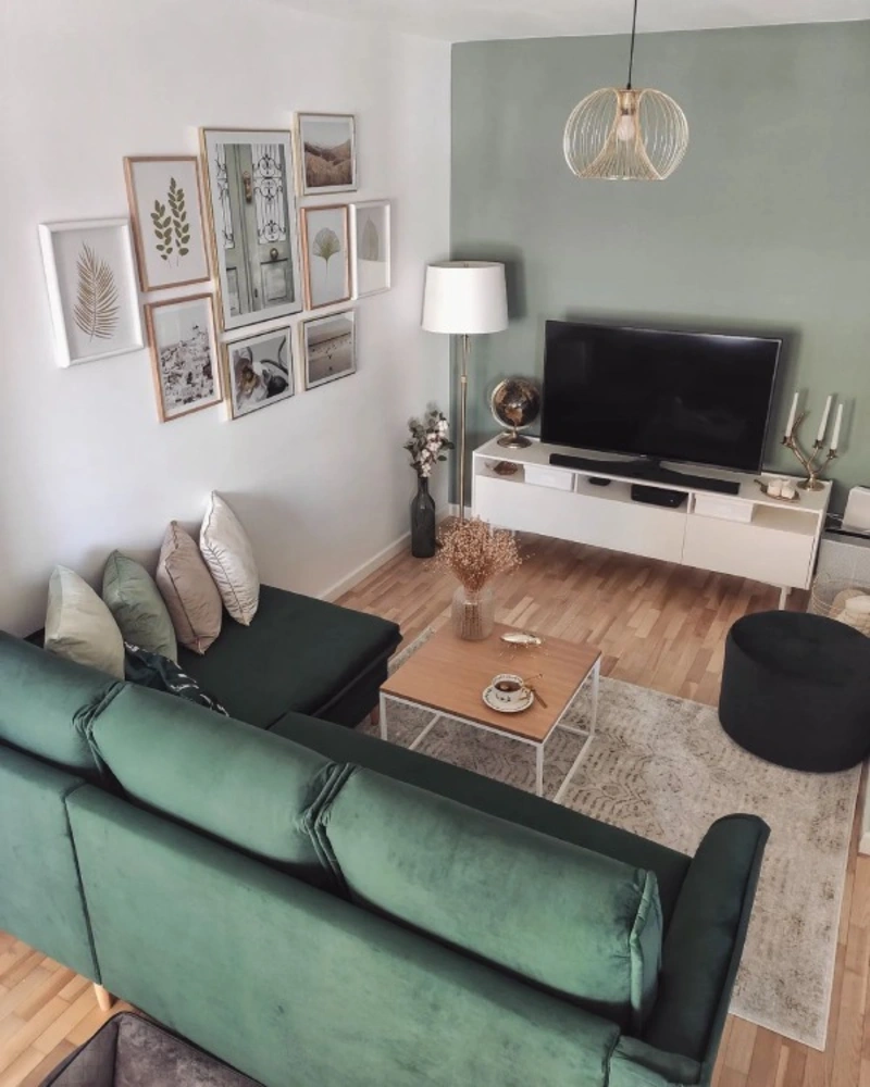 Sage Green Accent TV Wall with Emerald Sectional and Cage Pendant Light