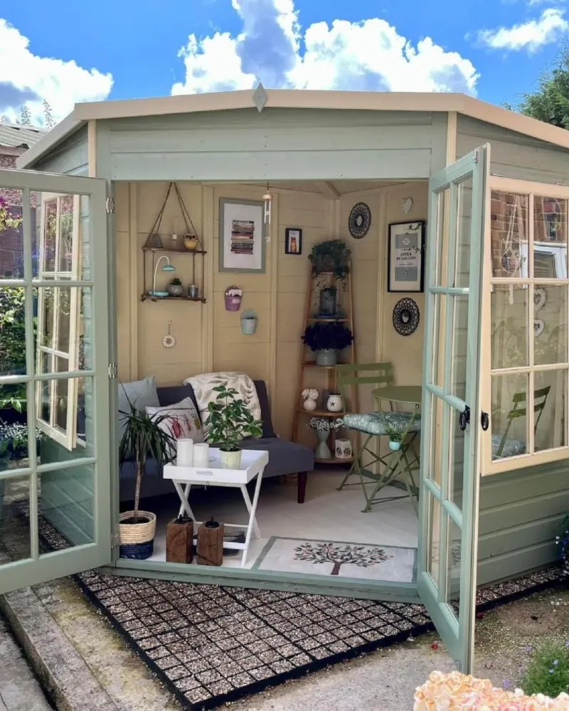 Sage Green Corner Summerhouse with Gray Loveseat and Folding Bistro Set