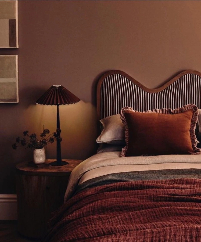 Scalloped Headboard with Striped Upholstery and Ruffled Velvet Cushions