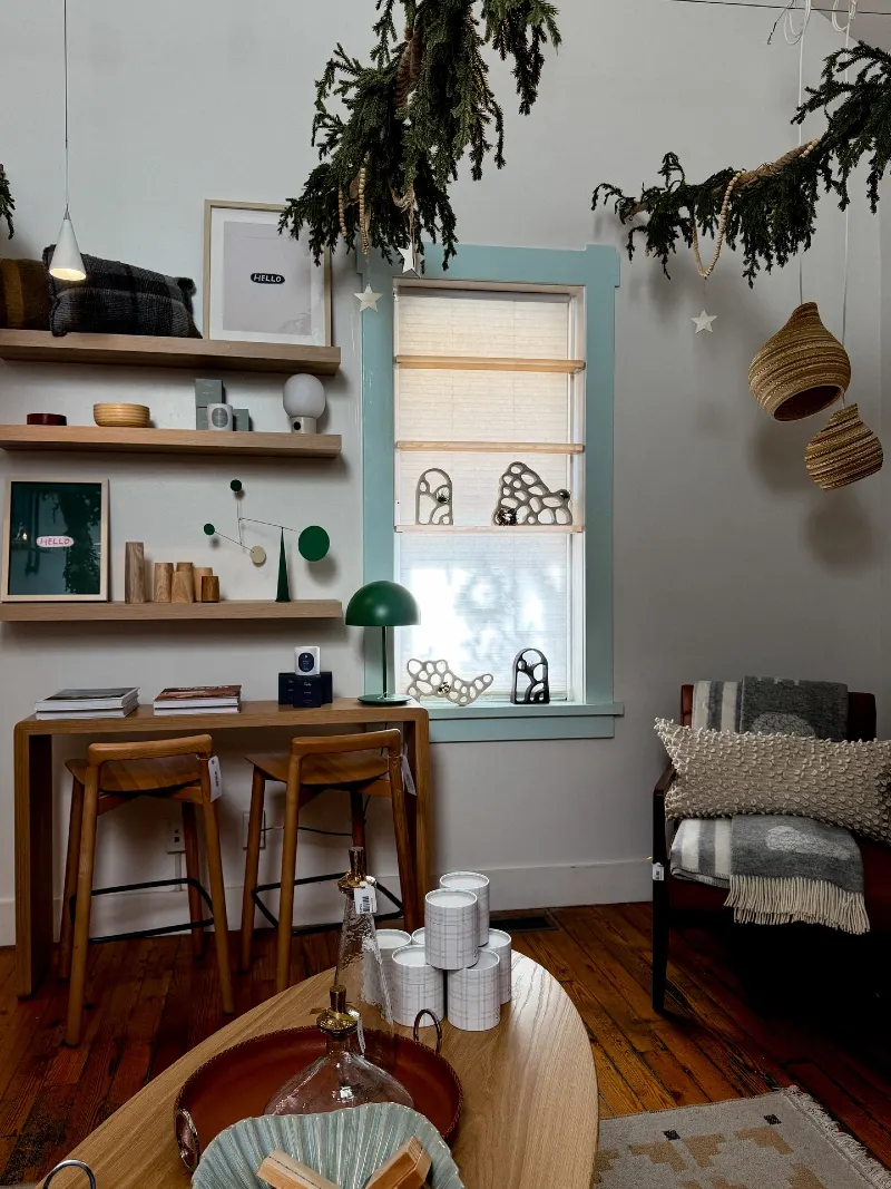 Scandinavian Workspace Nook with Light Wood Floating Shelves and Evergreen Garlands