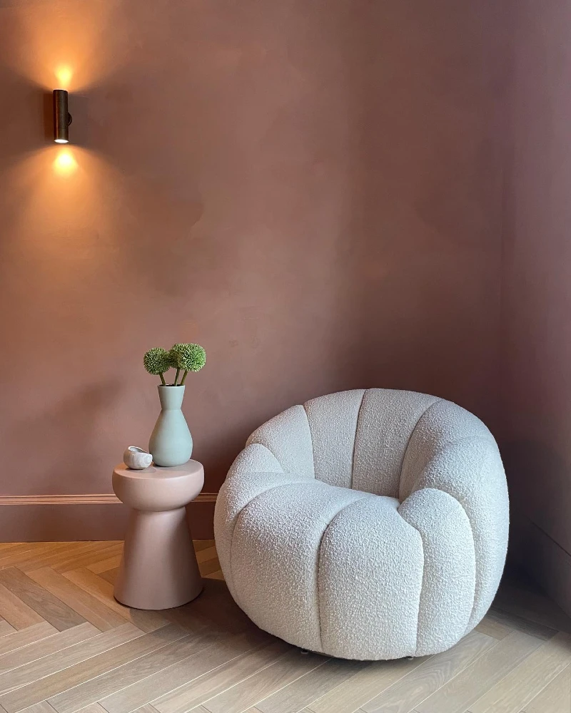 Sculptural Bouclé Chair with Warm Terracotta Wall