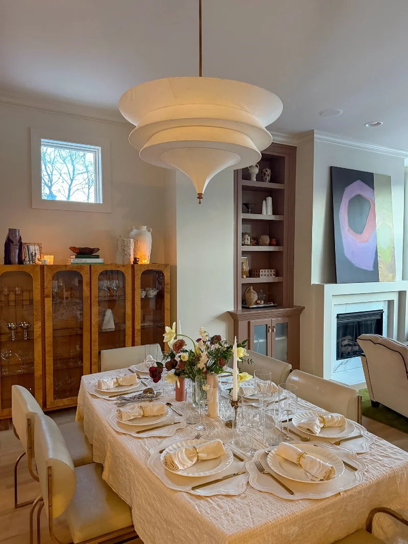 Sculptural Tiered Pendant Light with Burl Wood Cabinet and Scalloped Table Setting