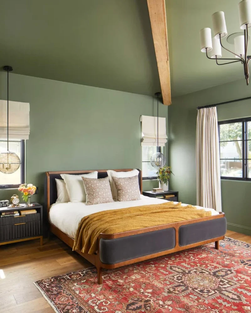 Sloped Olive Green Ceiling and Matching Walls with Exposed Wooden Ridge Beam and Vintage Medallion Rug