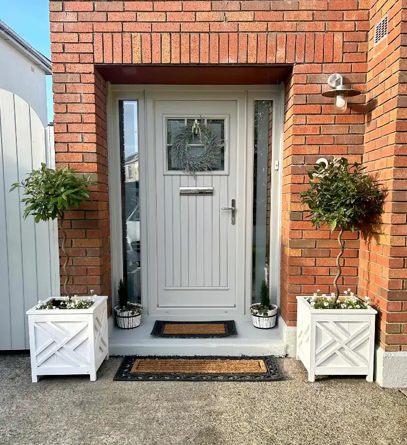 Soft Putty Front Door with Slim Sidelights and White Planter Boxes