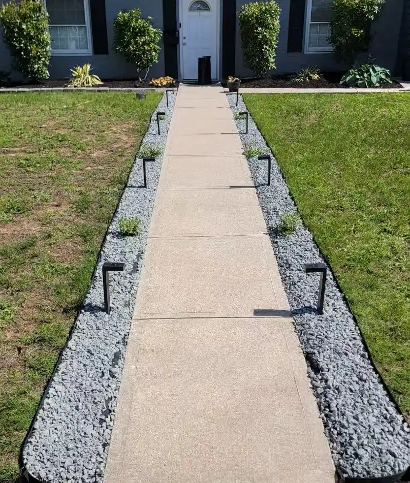 Straight Concrete Walkway with Gravel Side Borders and Modern Path Lights