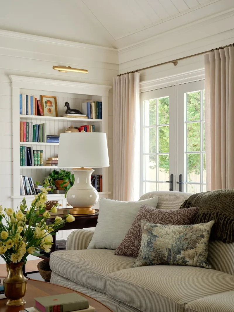 Striped Upholstered Sofa with Ceramic Gourd Lamp and Built-In Library Nook