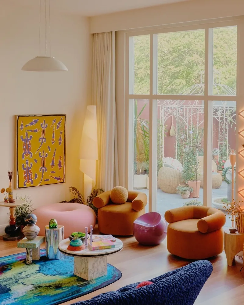 Sunny Living Area with Curvaceous Furniture and Yellow Art Accent