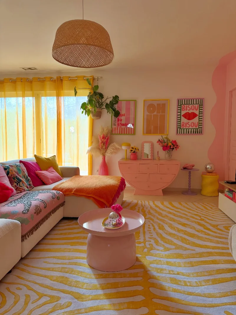Sunny Living Room with Zebra-Patterned Rug and Pink Curved Console