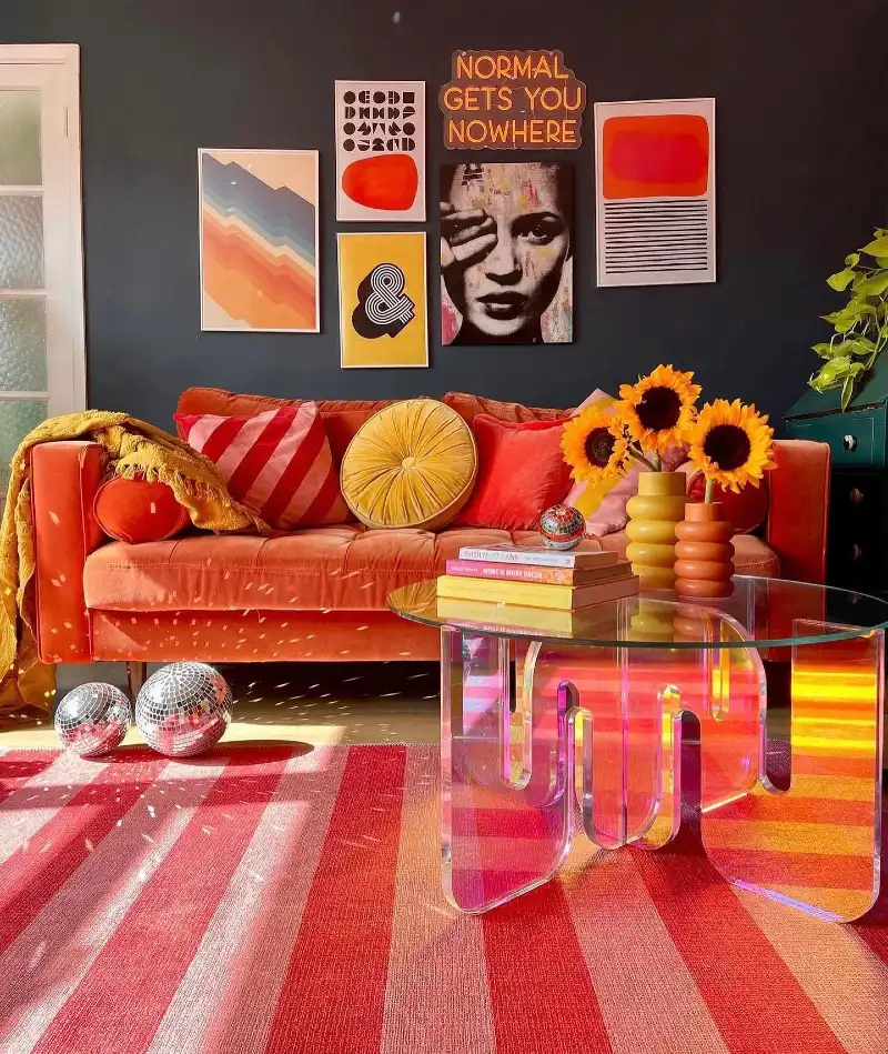 Sunset-Hued Living Room with Iridescent Coffee Table and Bold Art Gallery