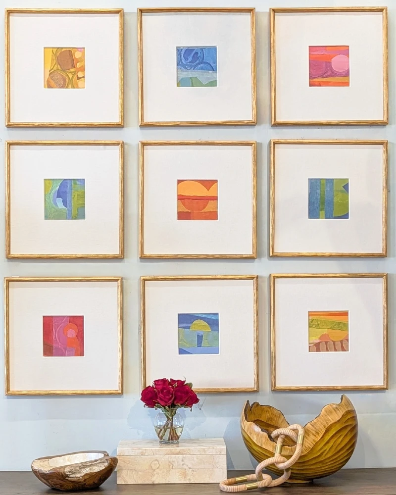Symmetrical Grid Gallery with Gold-Framed Abstract Prints, Marble Risers, and Sculptural Wood Bowls