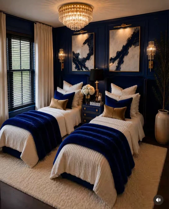 Symmetrical Navy Beds And Crystal Lighting