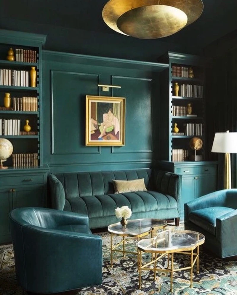Teal Library Walls with Matching Velvet Seating and Brass Tables