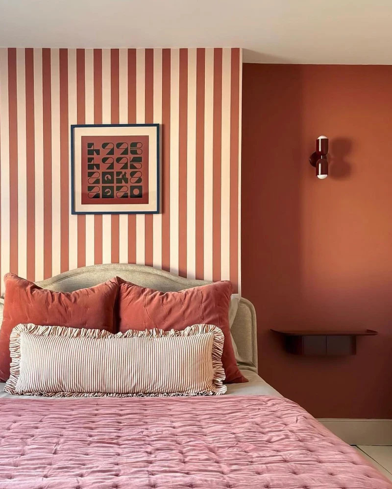 Terracotta Striped Accent Alcove and Solid Matte Bedroom Walls with Tufted Pink Bedding