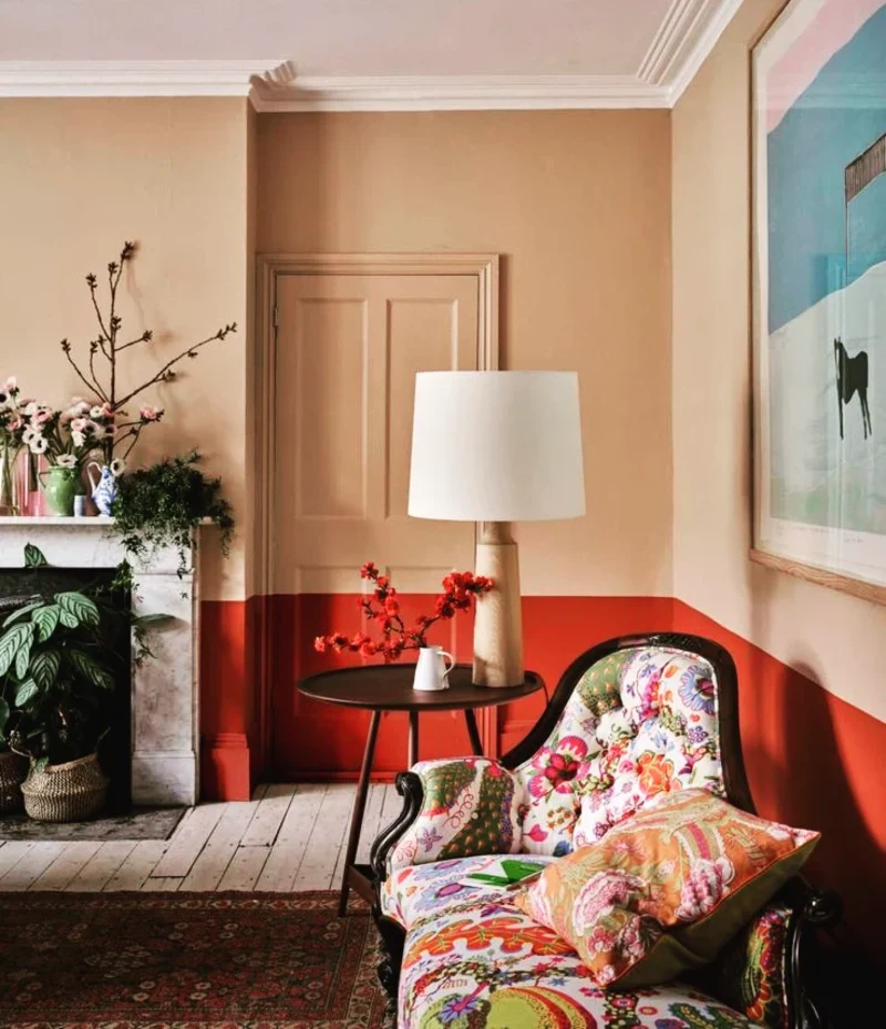 Terracotta and Beige Split-Color Wall with a Patterned Armchair and Painted Door