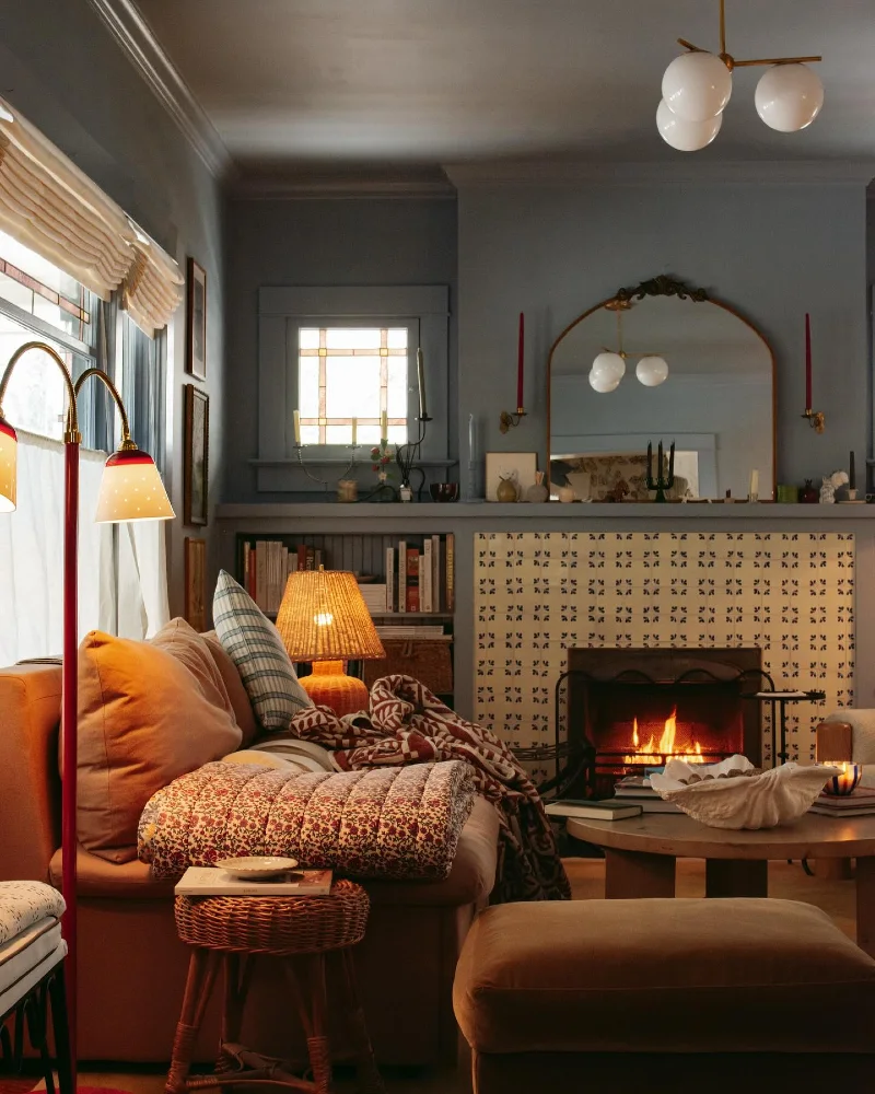 Tiled Fireplace with Arched Mirror and Layered Floral Textiles