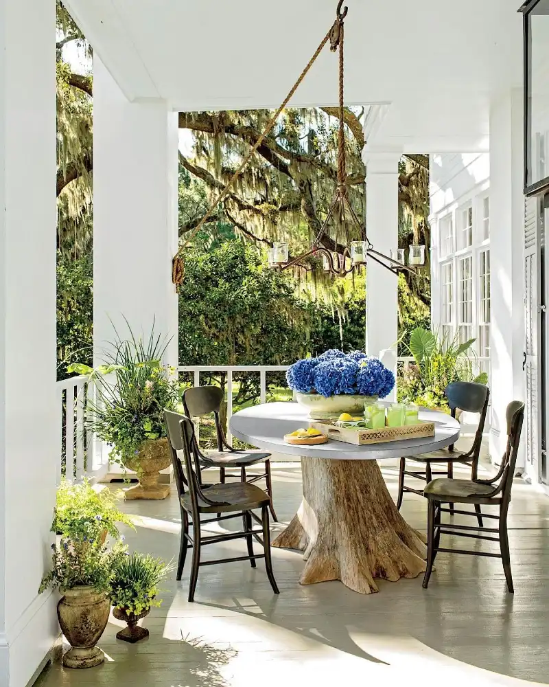 Tree Stump Dining Table with Wrought Iron Chandelier and Blue Hydrangeas