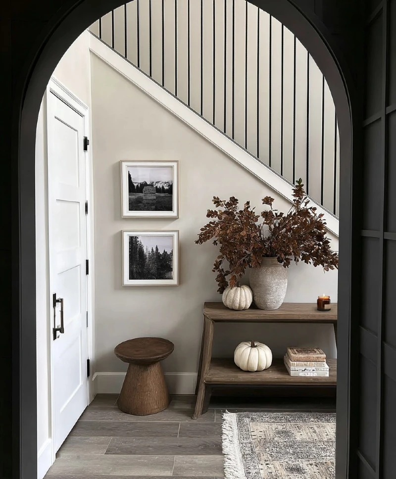 Two-Tier Wooden Console Table with Rust Foliage, Muted Pumpkins, and Stacked Books