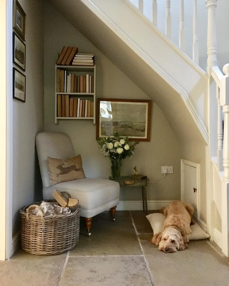 Under-Stair Reading Corner with Upholstered Slipper Chair and Stone Flooring