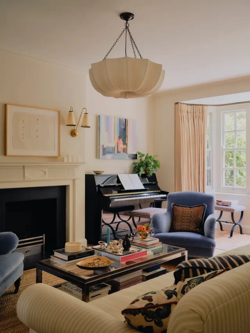 Velvet Armchairs with Black Piano Corner and Scalloped Pendant Lamp
