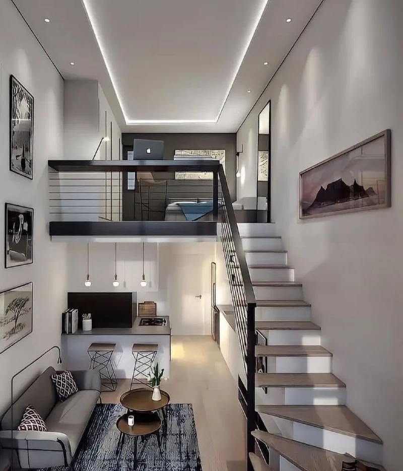 Vertical gallery wall with slim black loft railings and recessed ceiling cove lighting