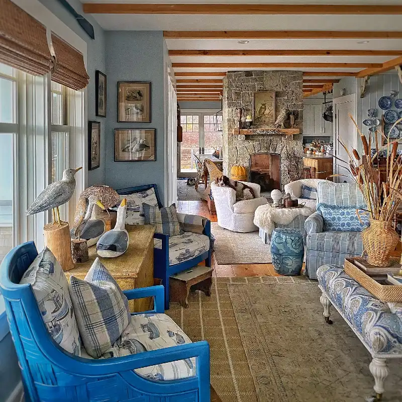 Vibrant Blue Armchairs with Carved Shorebird Figurines and Stone Fireplace