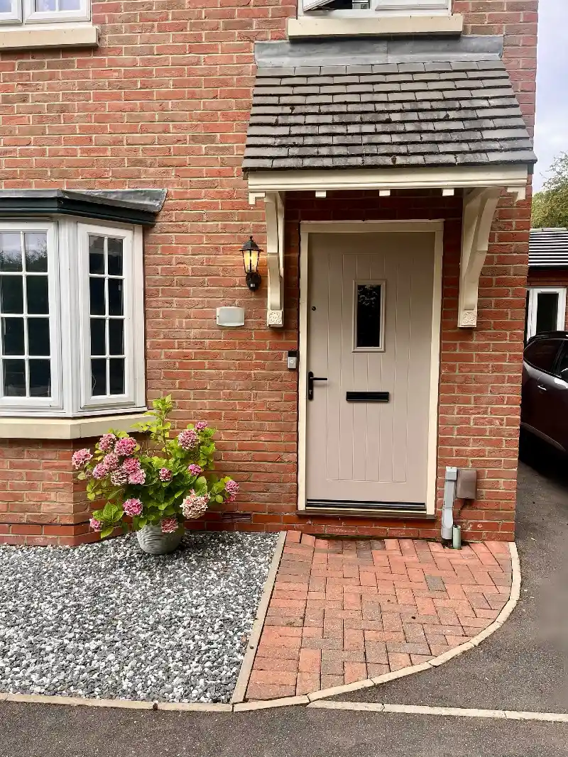 Warm Greige Front Door with Black Hardware and Cottage Canopy